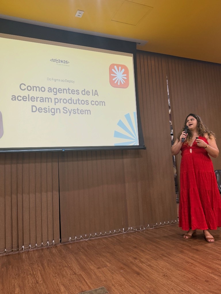 Rebeca Sousa speaking at MMMT 2026 by Developer Girls, with the From Figma to Deploy slide behind her.